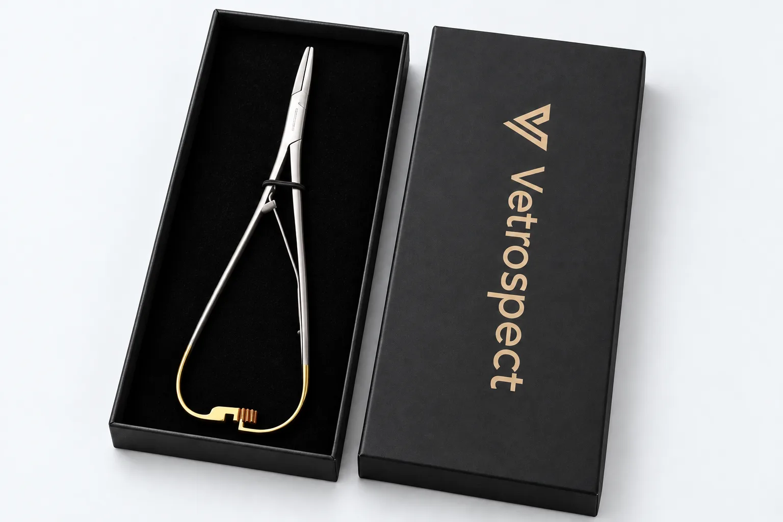 Vetrospect Mathieu needle holder with gold-coloured spring in its open black presentation box, Vetrospect logo in gold on the lid